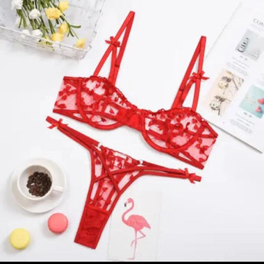 a pair of red bras next to a cup of coffee