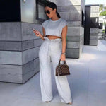 a woman in a grey crop top and matching pants