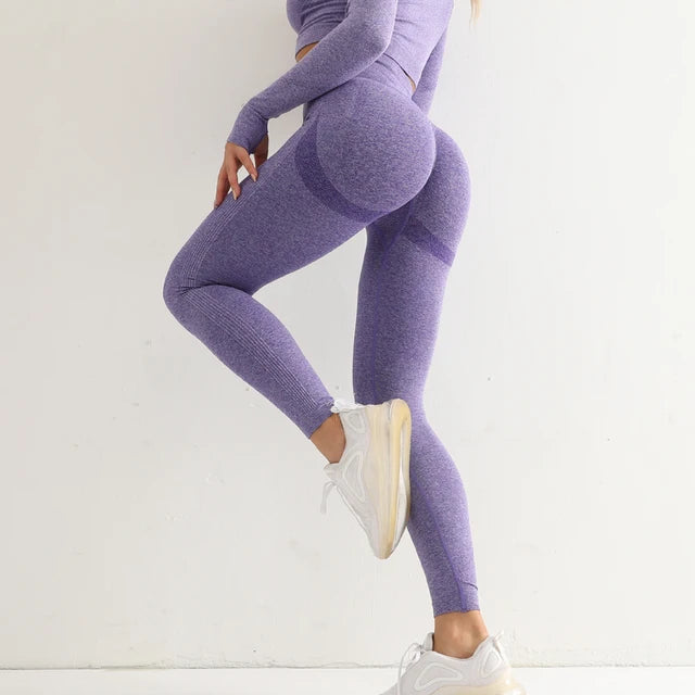 a woman in a purple sports suit posing for a picture