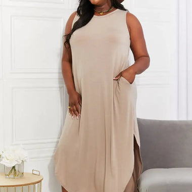 a woman wearing a tan dress and a brown hat