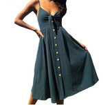 a woman wearing a green dress with buttons