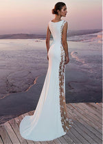 a woman in a white dress standing on a dock