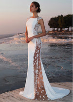 a woman in a white dress standing on a dock