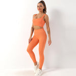 a woman in an orange sports bra top and leggings