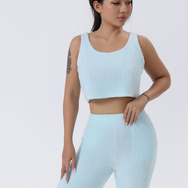 a woman in a light blue crop top and leggings