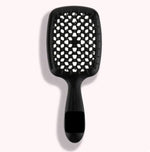 a black brush with white dots on it