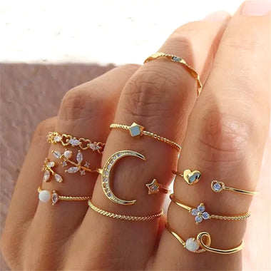 a woman's hand with five different rings on it