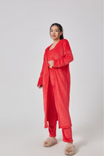 a woman wearing a red robe and slippers