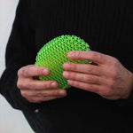 a close up of a person holding a green object