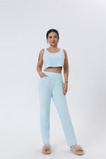 a woman wearing a crop top and pants