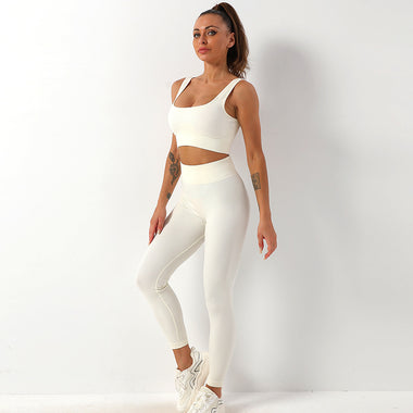 a woman in a white sports bra top and leggings