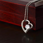 a heart shaped necklace with a diamond in the middle