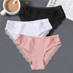 three women's panties with laces and a cup of coffee