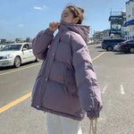 a woman standing on the side of a road next to a parking lot