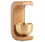 a golden singing bowl on a wooden stand