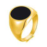 a gold signet ring with a black stone