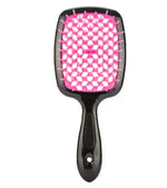 a pink and black hair brush on a white background