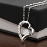 a necklace with a heart shaped diamond on it