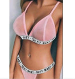 a woman wearing a pink bra and panties