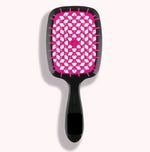 a pink and black hair brush on a white background