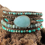 a stack of bracelets with turquoise beads and a stone