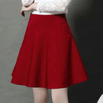 a woman in a white shirt and red skirt