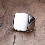 a silver ring sitting on top of a wooden table