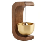 a wooden stand with a gold bowl on it