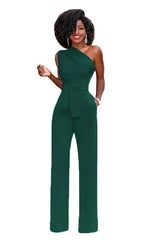 a woman in a green jumpsuit with a large afro