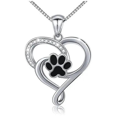 a heart shaped pendant with a dog paw inside of it