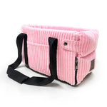 a pink corded purse with a black strap