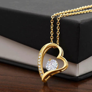 a heart shaped necklace with a diamond in the middle