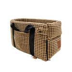 a brown basket with a black ribbon on it