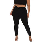 a woman wearing black pants and a crop top