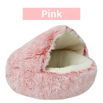 a pink cat bed with a white bottom