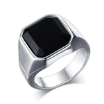 a ring with a black stone on it