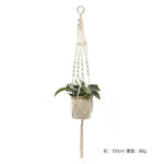 a white hanging planter with a plant in it