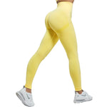 a woman in a yellow sports bra top and leggings