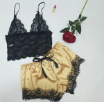 two lingerie sets with a rose on a table