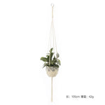 a white hanging planter with a plant in it