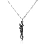 a silver necklace with a small figure on it