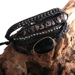 a stack of black leather bracelets with beads