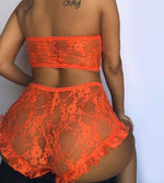 a woman in an orange lingerie is posing for the camera