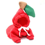 a red stuffed animal with a green hat