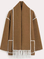 a brown jacket with white trims and fringes