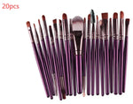 a bunch of purple makeup brushes sitting on top of each other