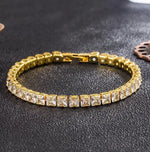 a gold bracelet on a black table