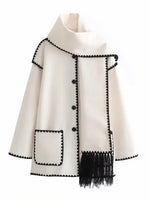 a white jacket with black trims and a black fringe