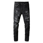 a pair of black ripped jeans with a white background