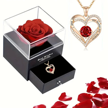 a necklace with a rose in a box and a rose in a box